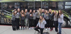 Photo of the volleyball team outside the team bus prior to departing for the State Finals in Bozeman