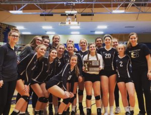 A photo of the Volleyball team holding their 2nd Place Trophy following the completion of the game in Dillon