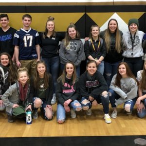The High School Student Council and volunteers stand in the high school gymnasium and pose for a picture after delivering the food to the Stevensville Food Bank