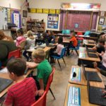 A classroom of students at their desks using their new chromebooks