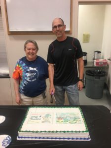 Ms Fisher and Mr Johnson Cut a cake