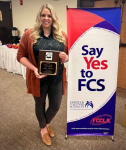 photo of mrs amy taxton with her award for FCS teacher of the year